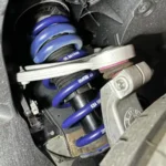 H&R lowering springs installed on a BMW front strut